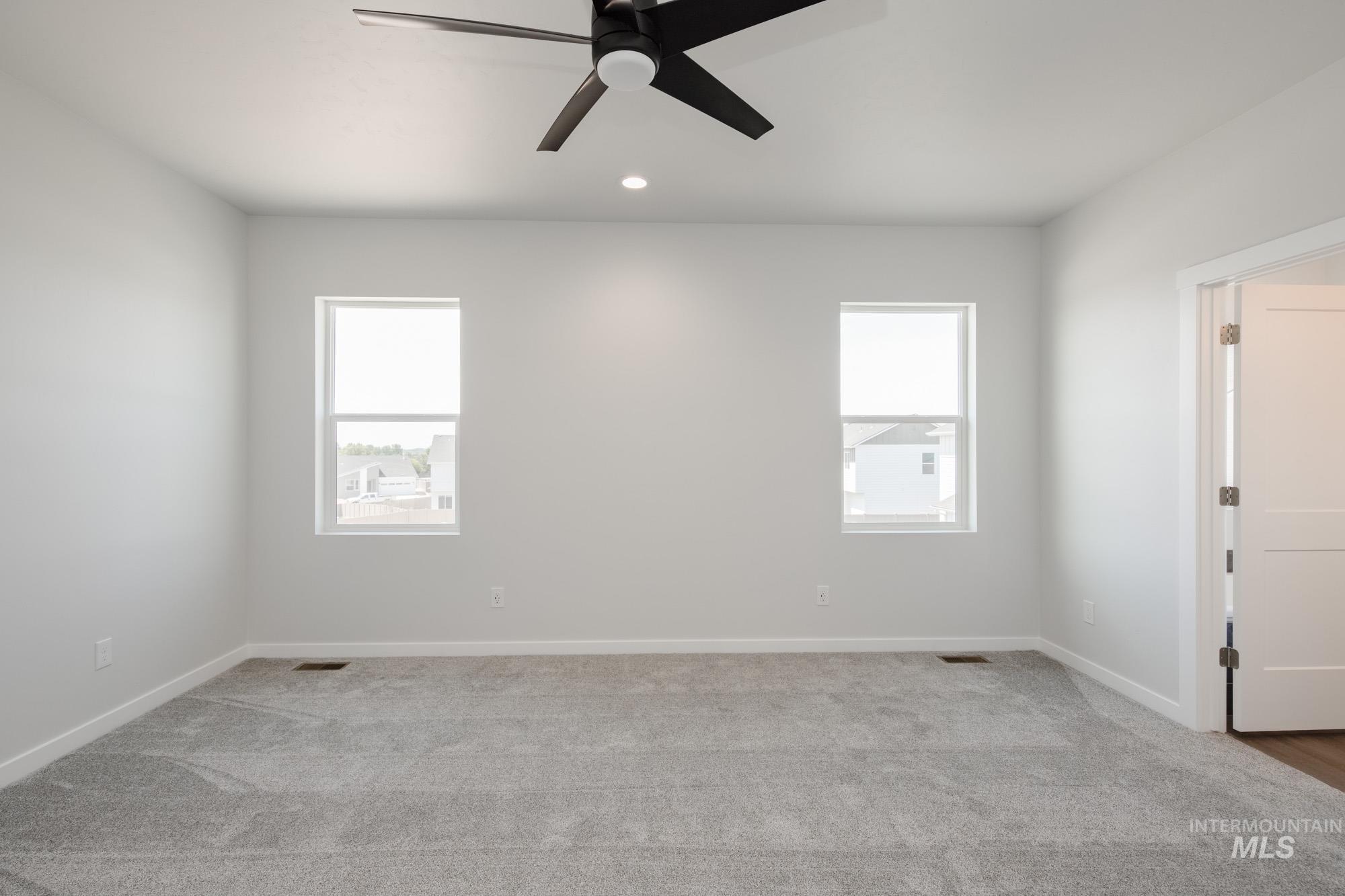 6447 South Sunfish Way Boise, ID 83709 - Photo 16 of 29 Unfurnished room with carpet, ceiling fan, and recessed lighting