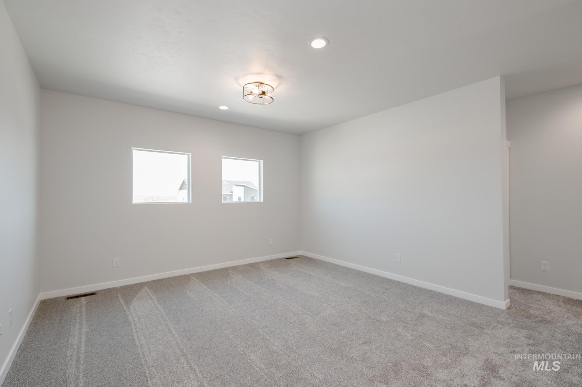 6447 South Sunfish Way Boise, ID 83709 - Photo 21 of 29 Unfurnished room with carpet and recessed lighting
