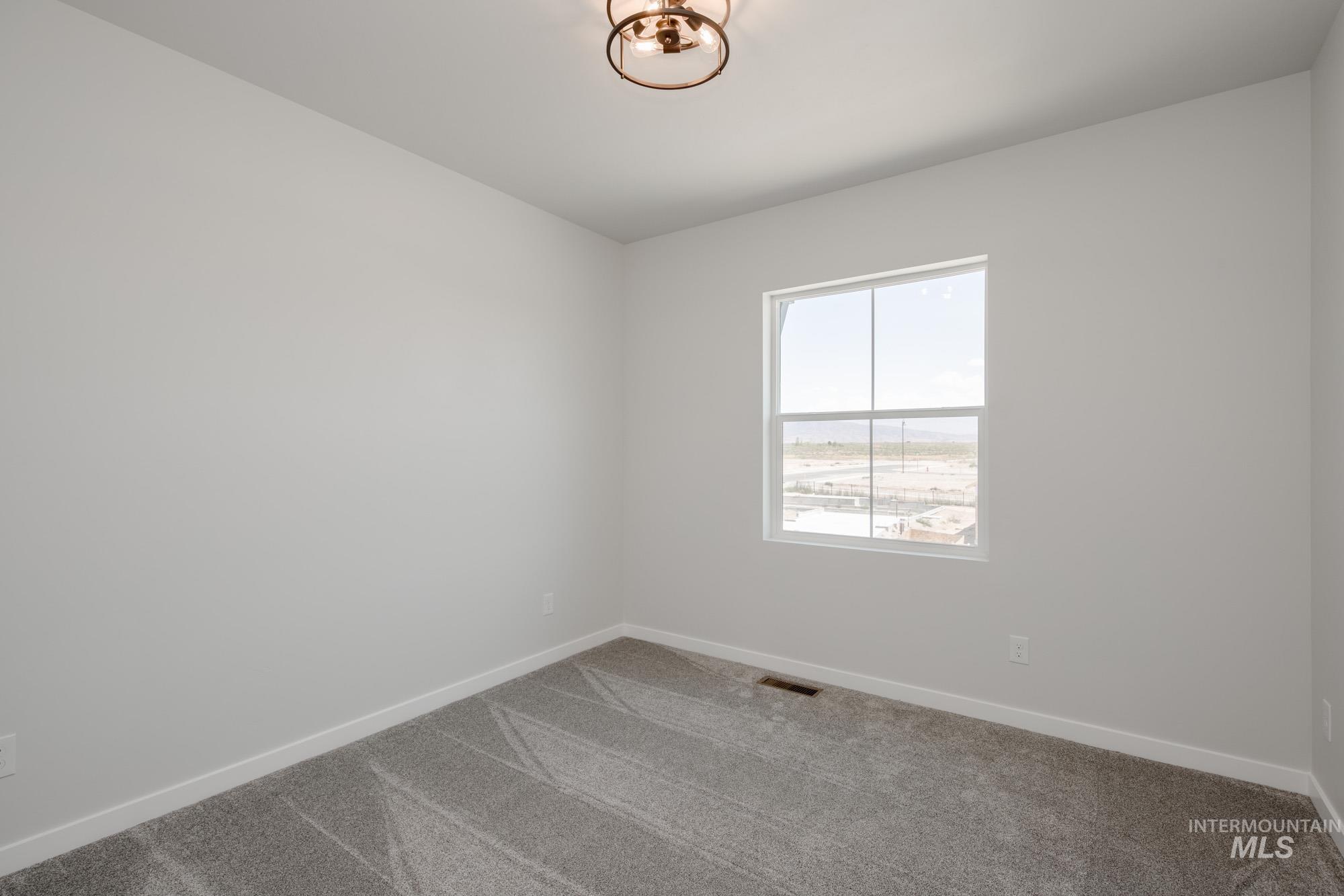 6447 South Sunfish Way Boise, ID 83709 - Photo 22 of 29 Carpeted empty room featuring baseboards