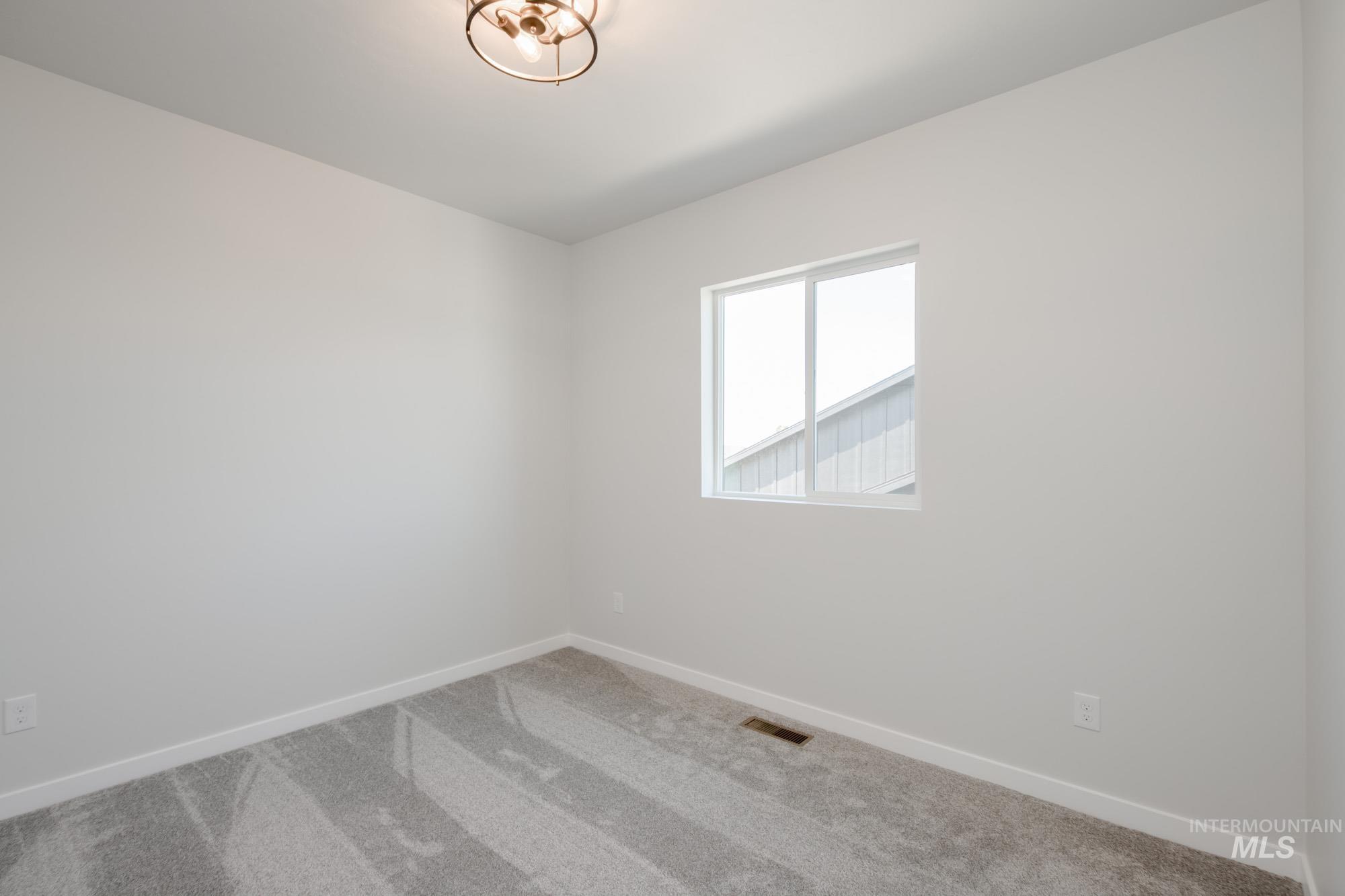 6447 South Sunfish Way Boise, ID 83709 - Photo 23 of 29 Unfurnished room featuring carpet floors and baseboards