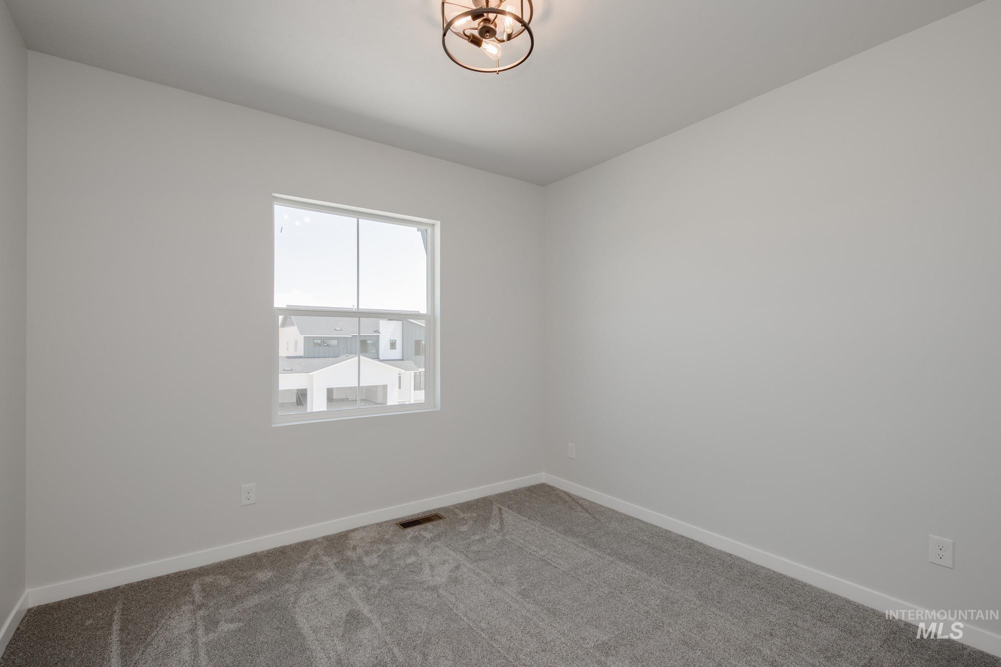 6447 South Sunfish Way Boise, ID 83709 - Photo 24 of 29 Empty room with carpet flooring and baseboards