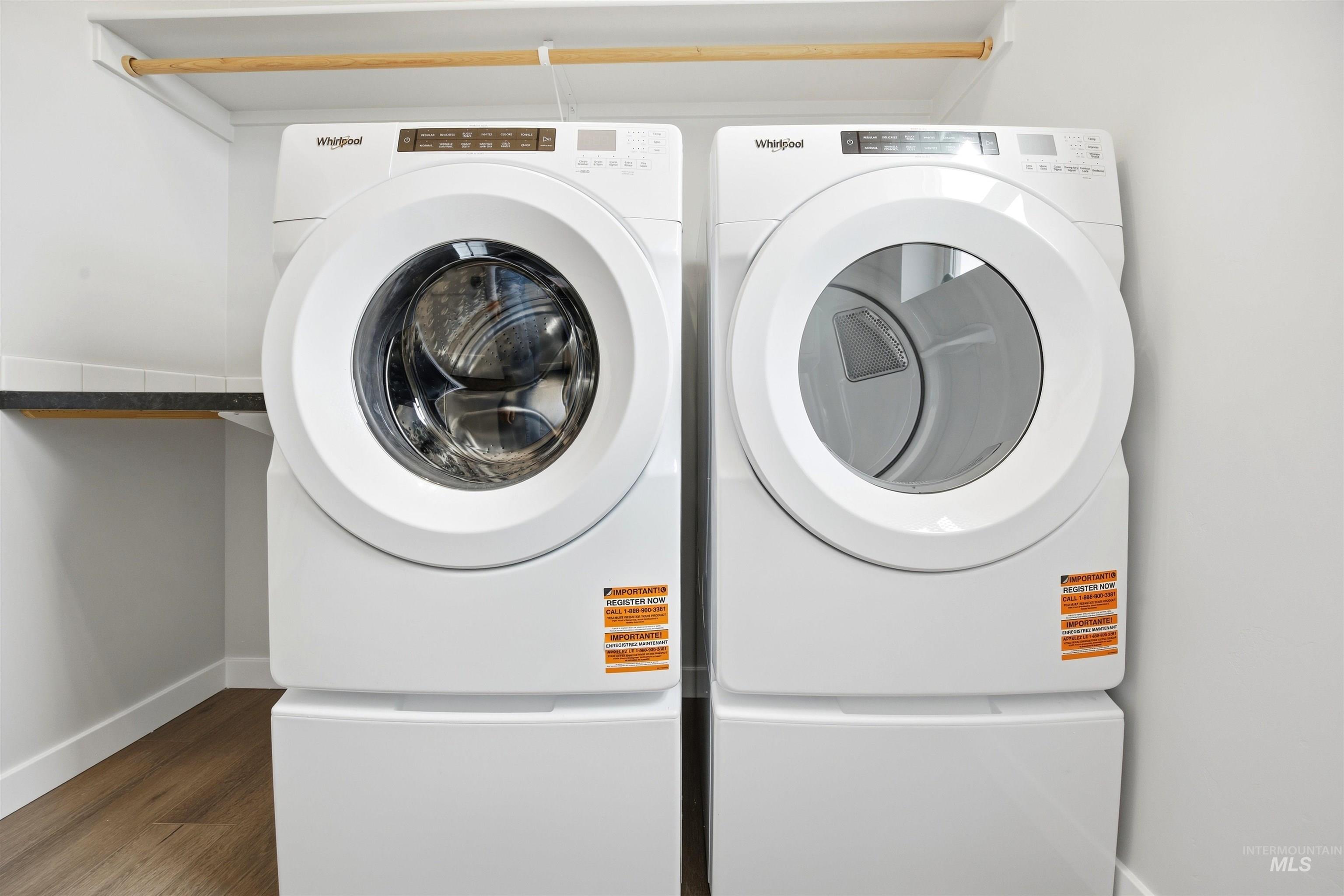 6447 South Sunfish Way Boise, ID 83709 - Photo 25 of 29 Dedicated laundry area featuring a front-loading washer and dryer set, elevated on pedestals