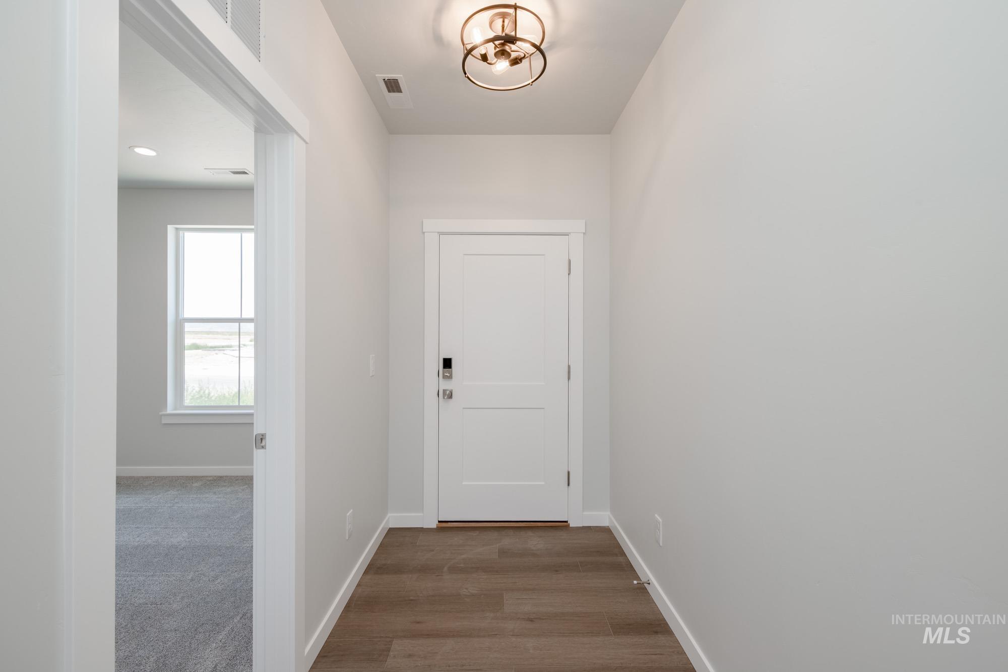 6447 South Sunfish Way Boise, ID 83709 - Photo 3 of 29 Hall with baseboards and wood finished floors