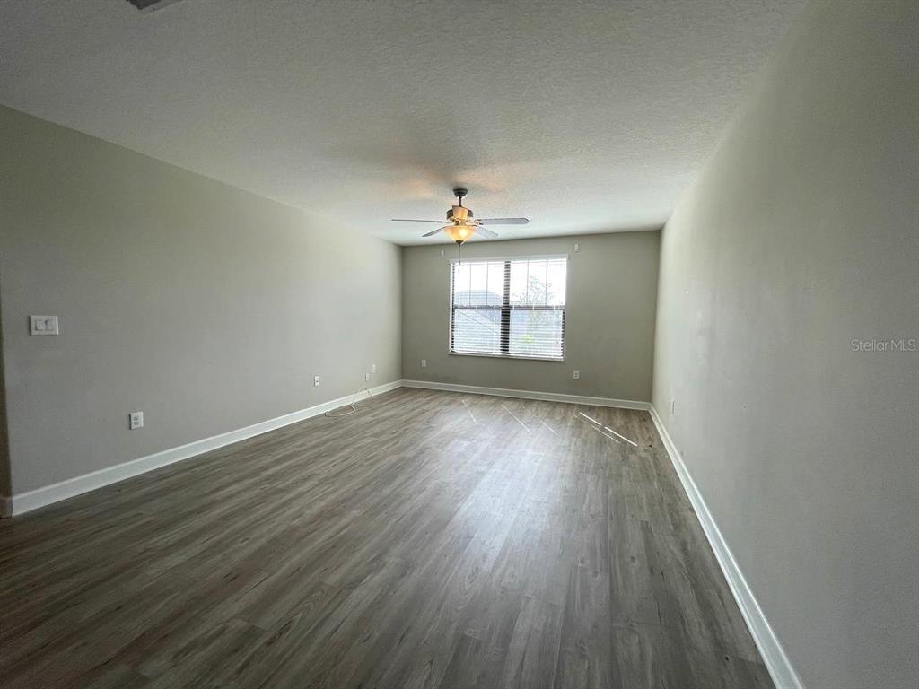 13339 Orca Sound Drive Riverview, FL 33579 - Photo 12 of 32 an empty room with wooden floor and windows
