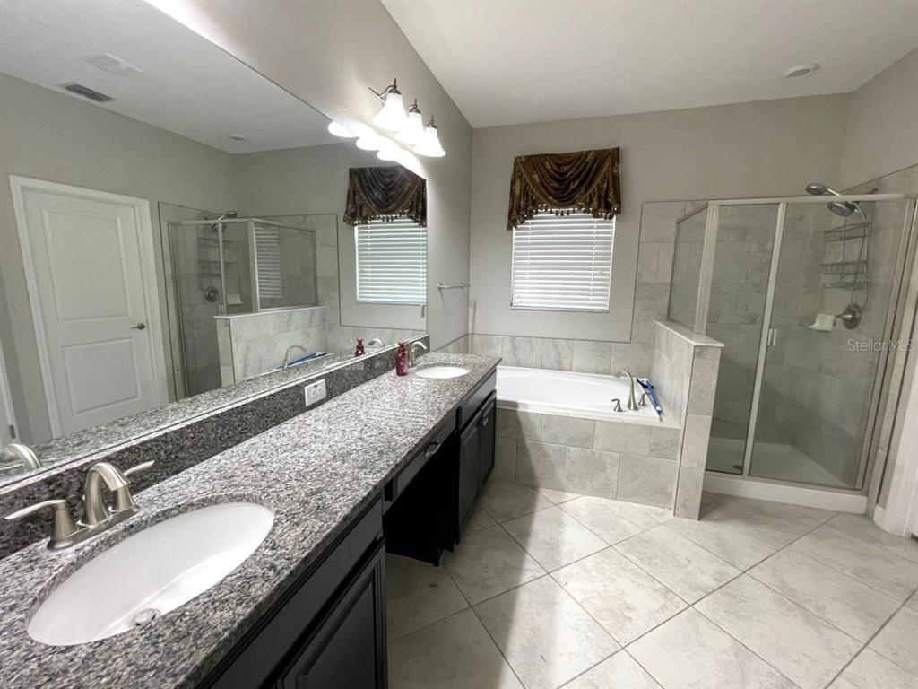 13339 Orca Sound Drive Riverview, FL 33579 - Photo 15 of 32 a bathroom with a granite countertop double vanity sink and mirror