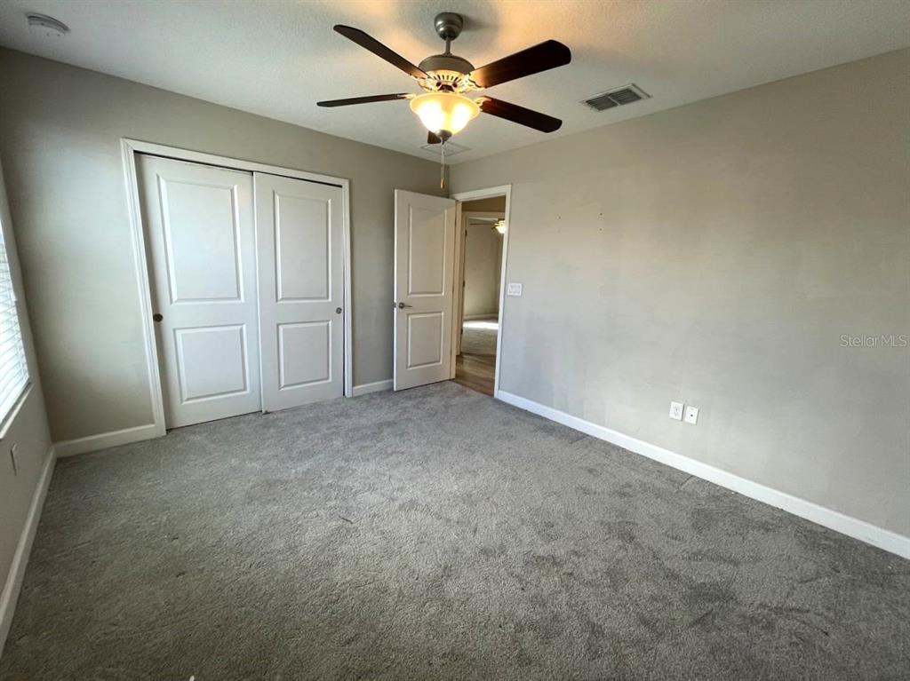 13339 Orca Sound Drive Riverview, FL 33579 - Photo 17 of 32 an empty room with closet and a ceiling fan