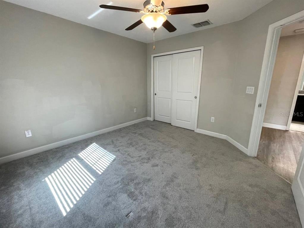 13339 Orca Sound Drive Riverview, FL 33579 - Photo 19 of 32 an empty room with wooden floor fan and windows