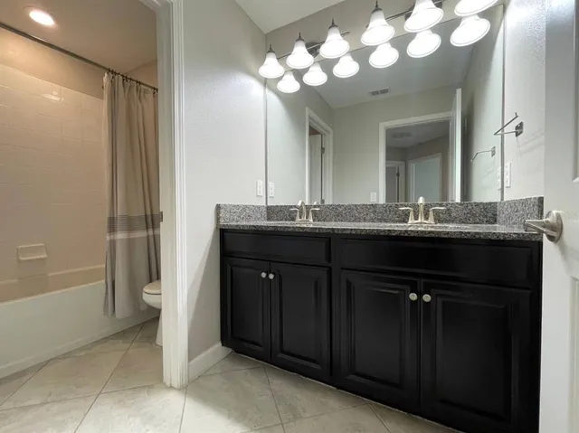 a white toilet sitting next to a bath tub