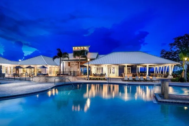 a view of a house with swimming pool and sitting area