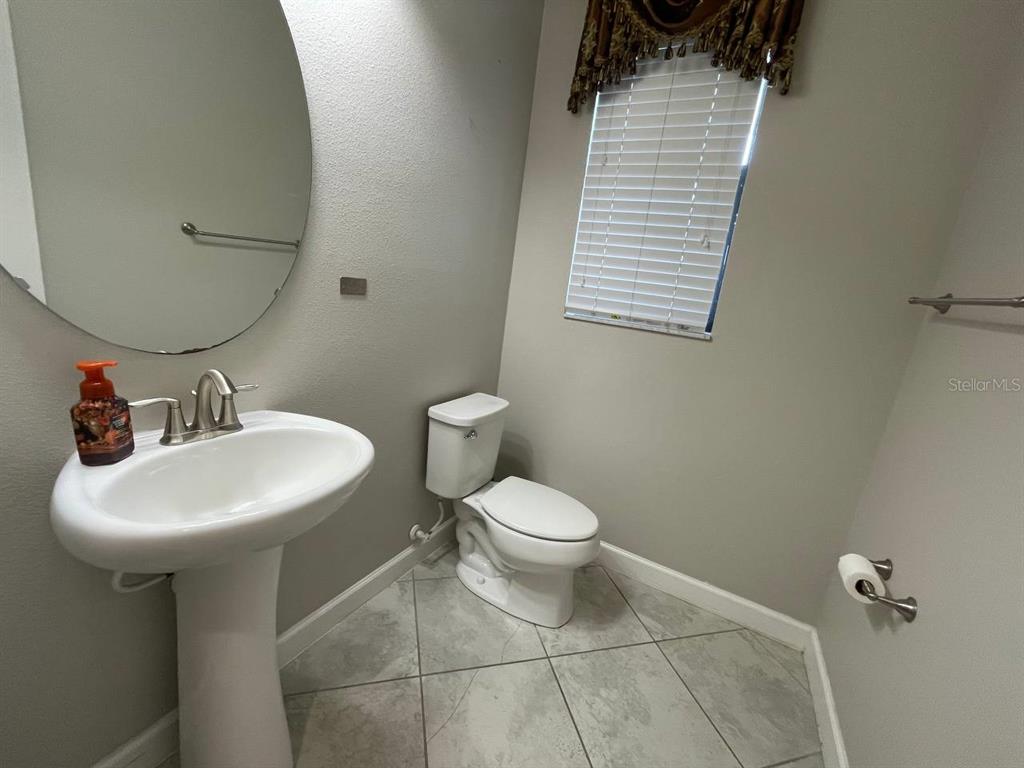 13339 Orca Sound Drive Riverview, FL 33579 - Photo 10 of 32 a bathroom with a sink a toilet and mirror
