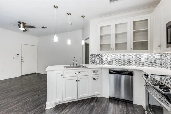 a kitchen with a sink stove and cabinets