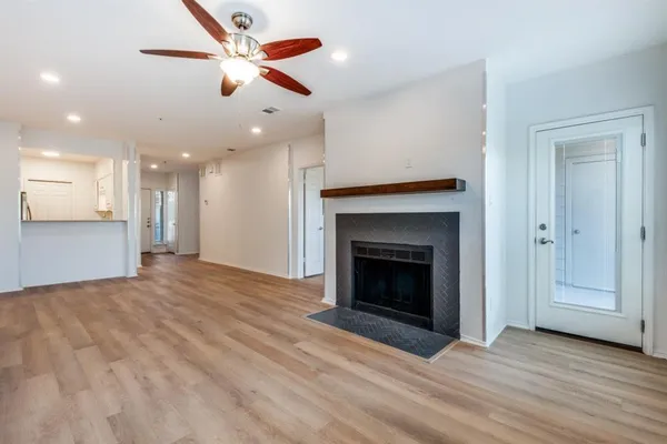 a view of an empty room with a fireplace