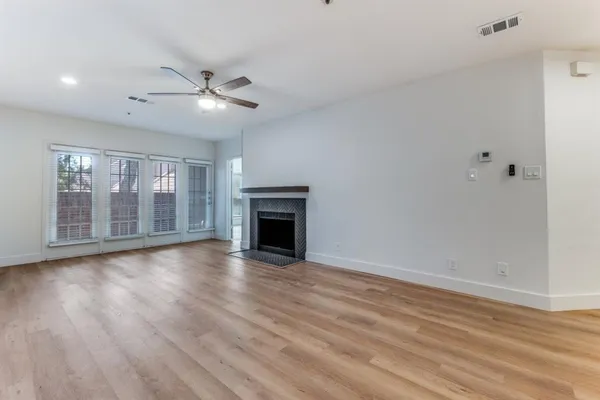 wooden floor in an empty room with a fireplace