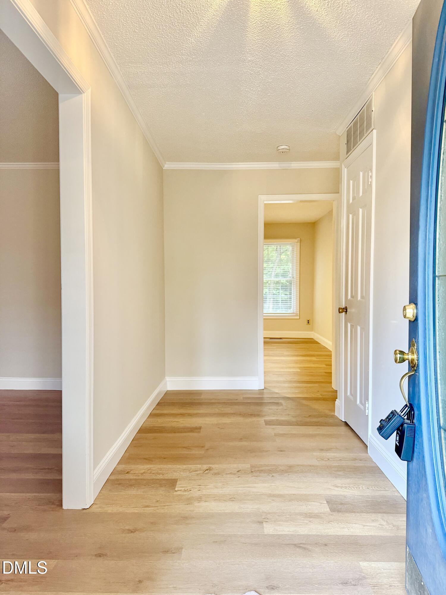 3517 Morningside Drive Raleigh, NC 27607 - Photo 3 of 14 a view of a hallway with wooden floor and a bathroom