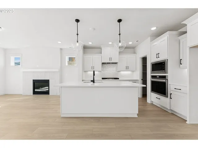 a view of kitchen with kitchen island stainless steel appliances counter top space
