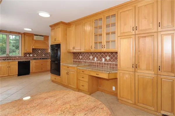 a kitchen with stainless steel appliances granite countertop a stove and a refrigerator