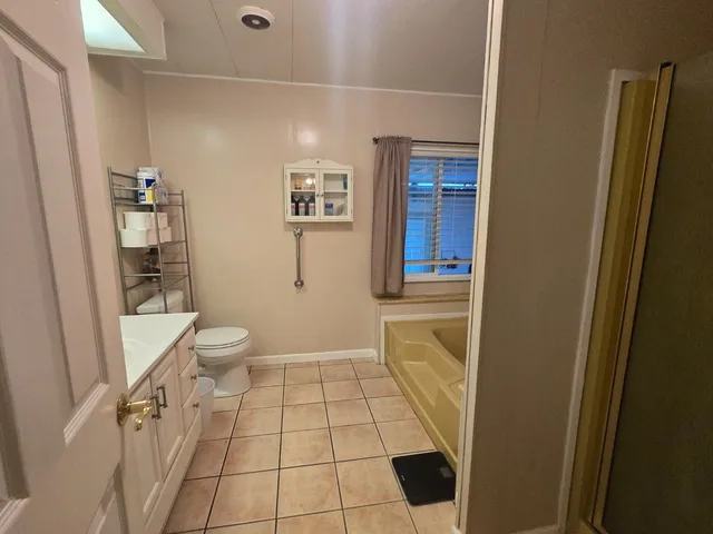 a bathroom with a sink a toilet and a shower