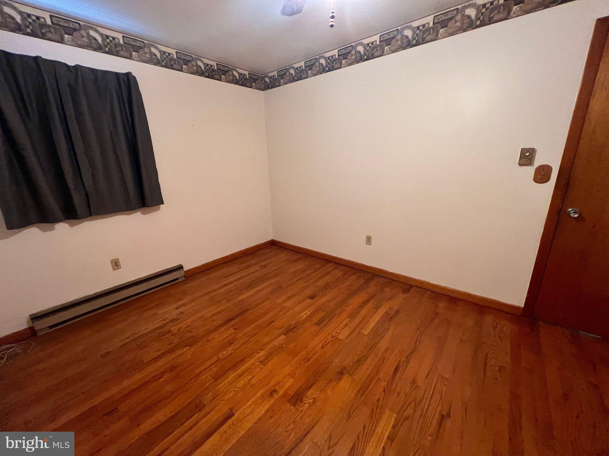 381 Co Rte 7/1 Augusta, WV 26704 - Photo 38 of 42 Spacious room with warm wooden floors.