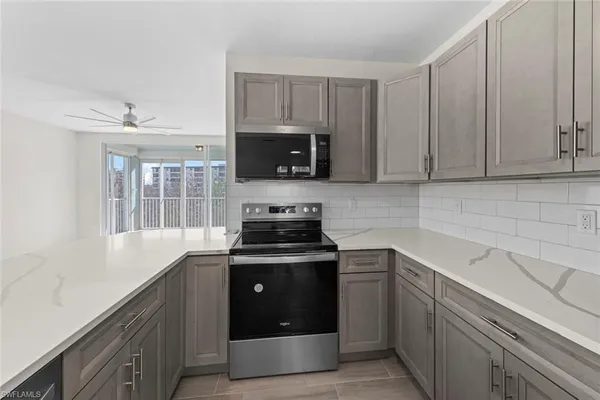 a kitchen with a sink and a stove top oven