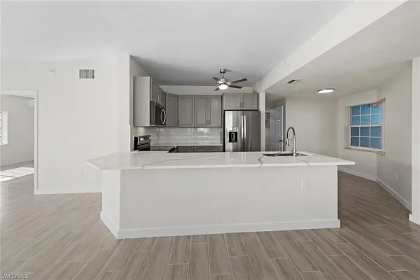 a view of kitchen with cabinets and wooden floor