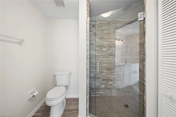 a bathroom with a toilet and a shower