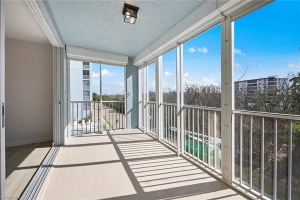 a view of a balcony with wooden floor