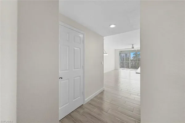 a view of hallway with wooden floor