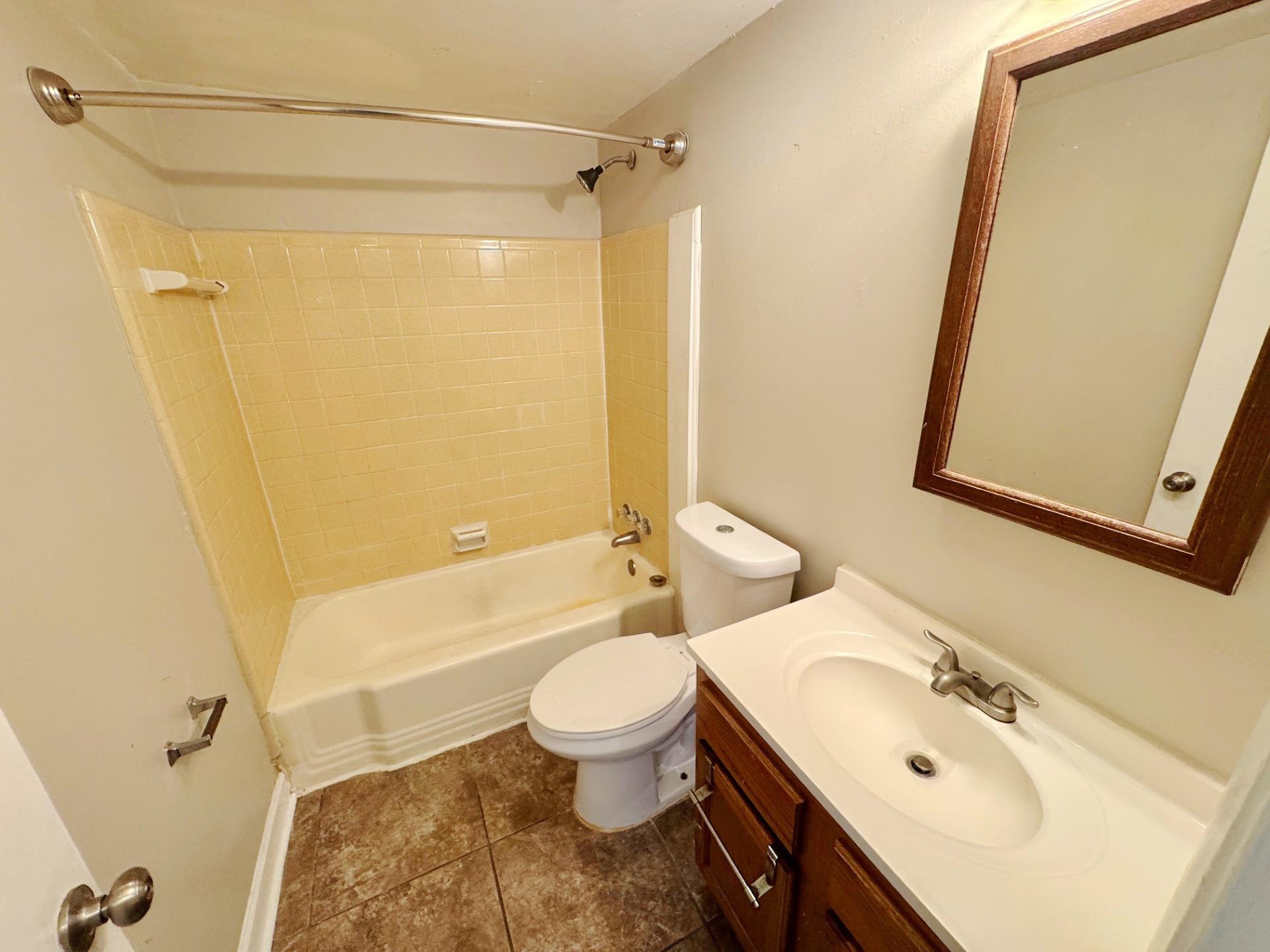 4890 Knight Arnold Road Memphis, TN 38118 - Photo 5 of 11 Full bathroom featuring vanity, tiled shower / bath combo, toilet, and tile patterned flooring