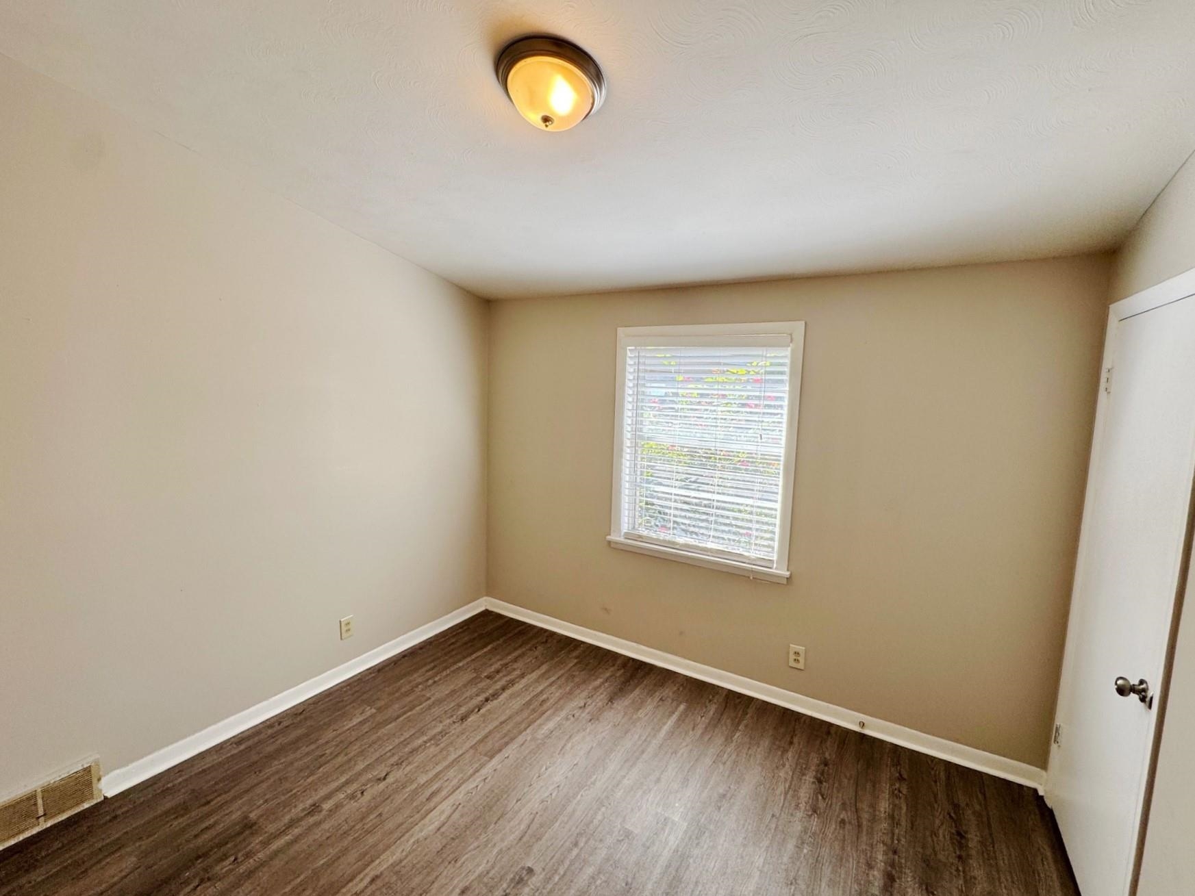 4890 Knight Arnold Road Memphis, TN 38118 - Photo 6 of 11 Spare room featuring hardwood / wood-style floors