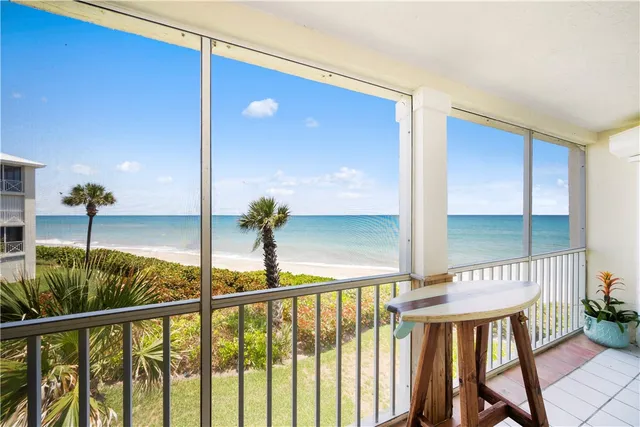 a dining room with furniture and large windows