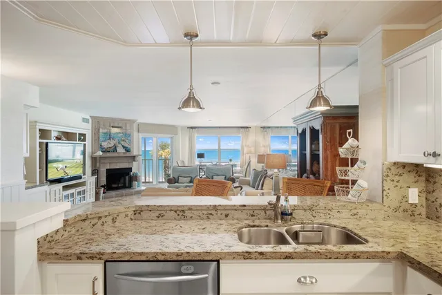 a kitchen with stainless steel appliances granite countertop a sink and stove top oven