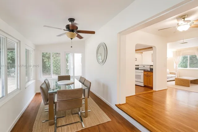 a view of a dining room with furniture window and wooden floor