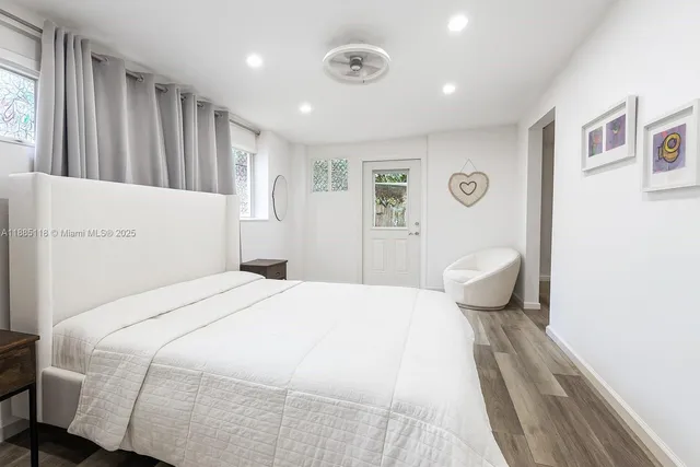 a spacious bedroom with a bed and a cabinets