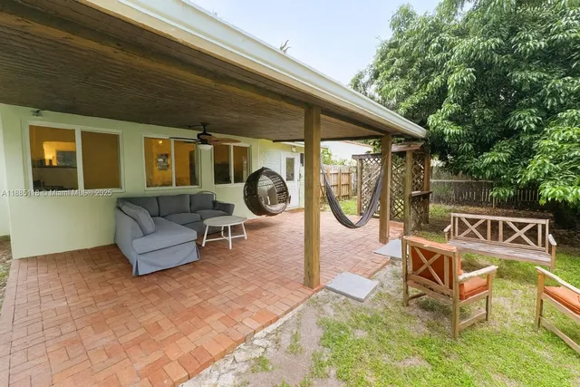 a backyard of a house with table and chairs