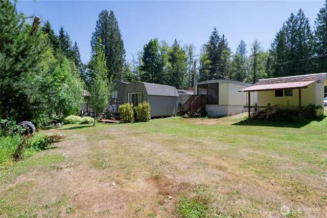 a view of a house with backyard and sitting area