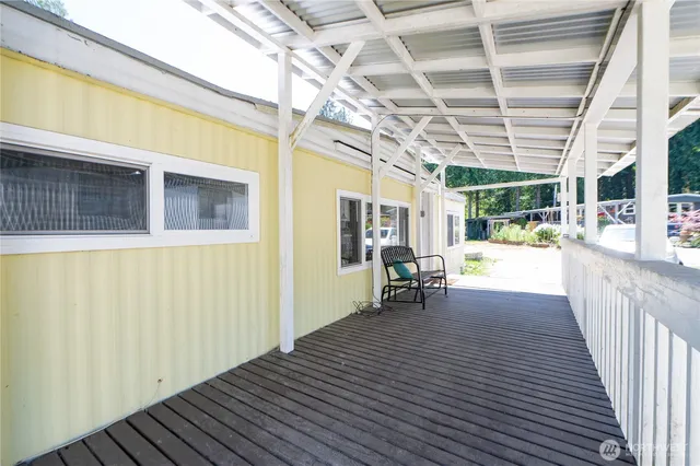 a view of a porch with wooden floor and iron stairs