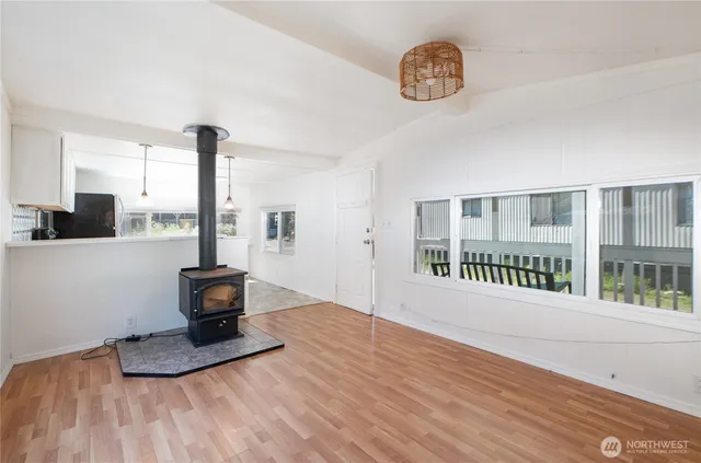 a view of a room with wooden floor and a window