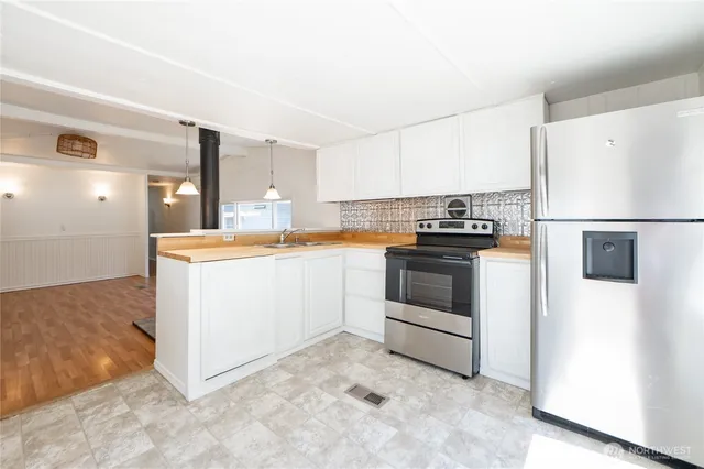 a kitchen with a stove a refrigerator and a sink