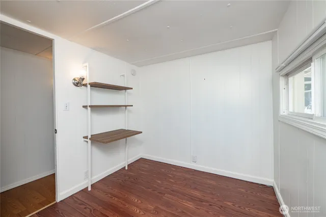 a view of a room with wooden floor