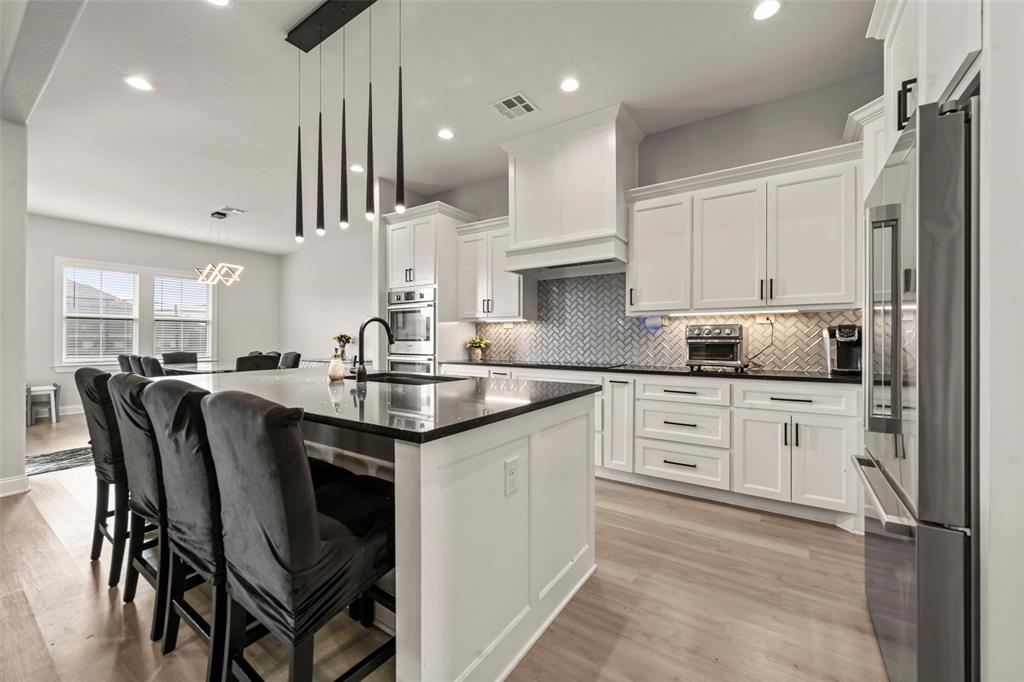 820 Forward Pass Drive Hewitt, TX 76643 - Photo 5 of 22 a kitchen with granite countertop a sink appliances cabinets and furniture