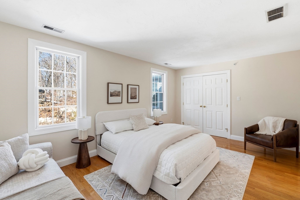 52 Packards Lane, Unit 4 Quincy, MA 02169 - Photo 16 of 40 a bedroom with a bed and wooden floor