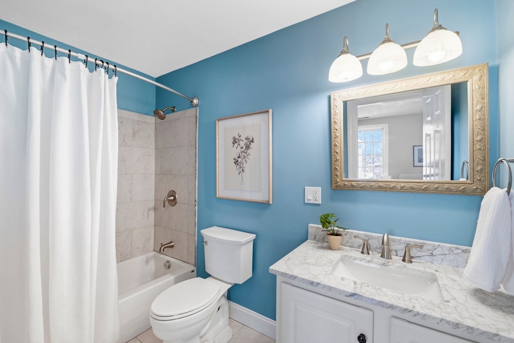 52 Packards Lane, Unit 4 Quincy, MA 02169 - Photo 17 of 40 a bathroom with a granite countertop sink mirror vanity and toilet