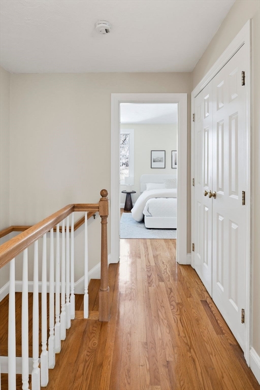 52 Packards Lane, Unit 4 Quincy, MA 02169 - Photo 18 of 40 a bedroom with a bed and wooden floor