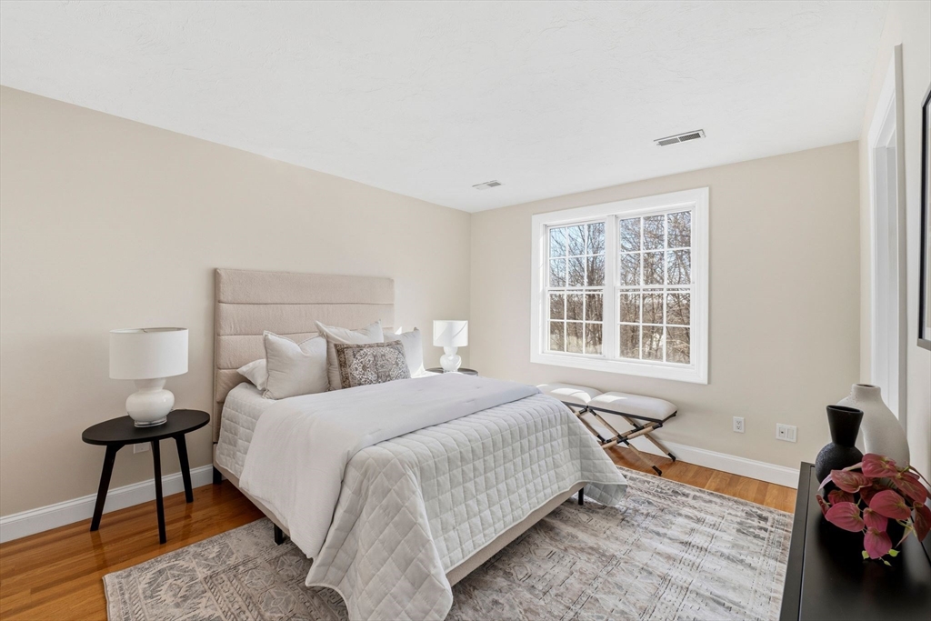 52 Packards Lane, Unit 4 Quincy, MA 02169 - Photo 19 of 40 a bedroom with a bed and a window