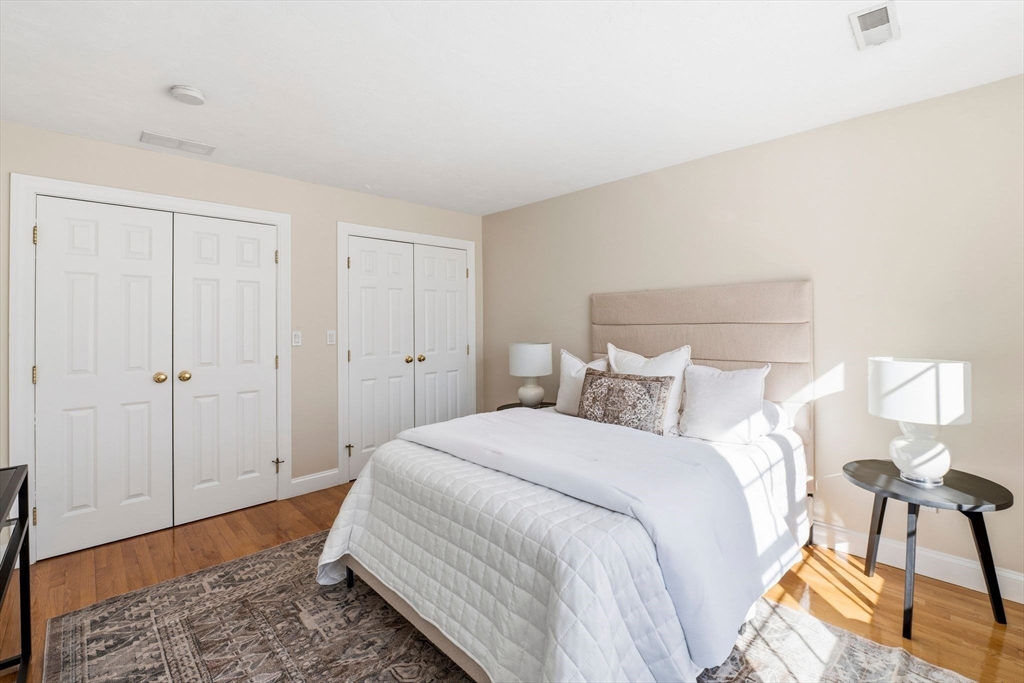 52 Packards Lane, Unit 4 Quincy, MA 02169 - Photo 20 of 40 a bedroom with a bed and a potted plant
