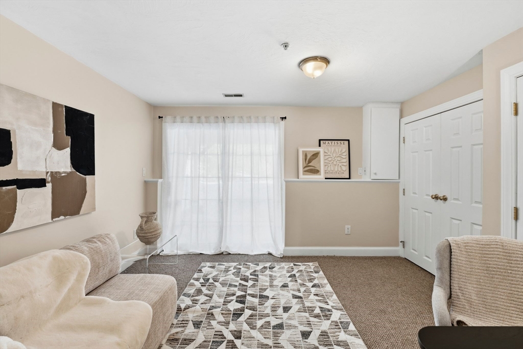 52 Packards Lane, Unit 4 Quincy, MA 02169 - Photo 23 of 40 a bedroom with furniture and a rug