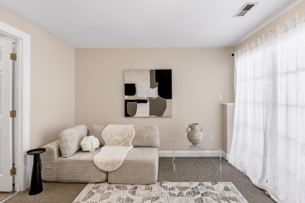 52 Packards Lane, Unit 4 Quincy, MA 02169 - Photo 25 of 40 a living room with furniture and a rug