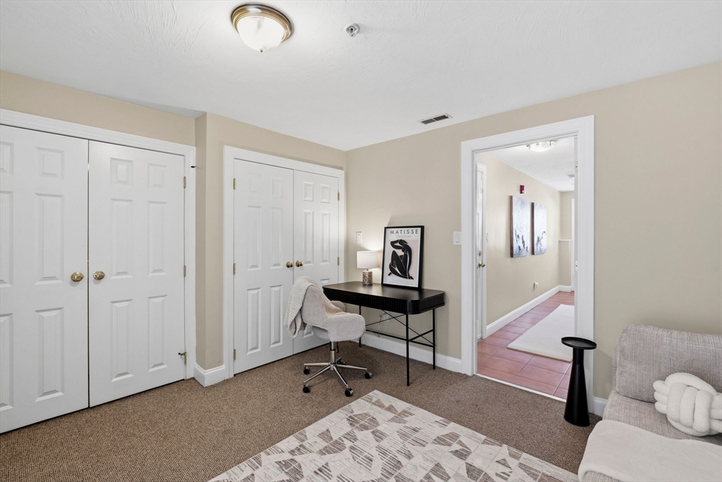 52 Packards Lane, Unit 4 Quincy, MA 02169 - Photo 26 of 40 a view of a workspace with furniture and wooden floor