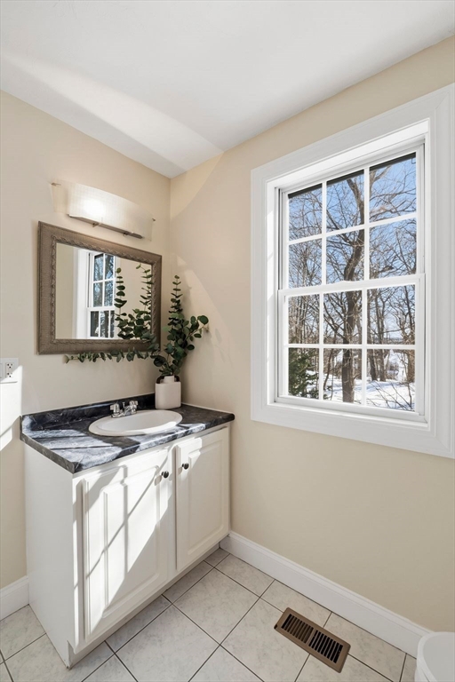 52 Packards Lane, Unit 4 Quincy, MA 02169 - Photo 29 of 40 a kitchen with a stove window and cabinets