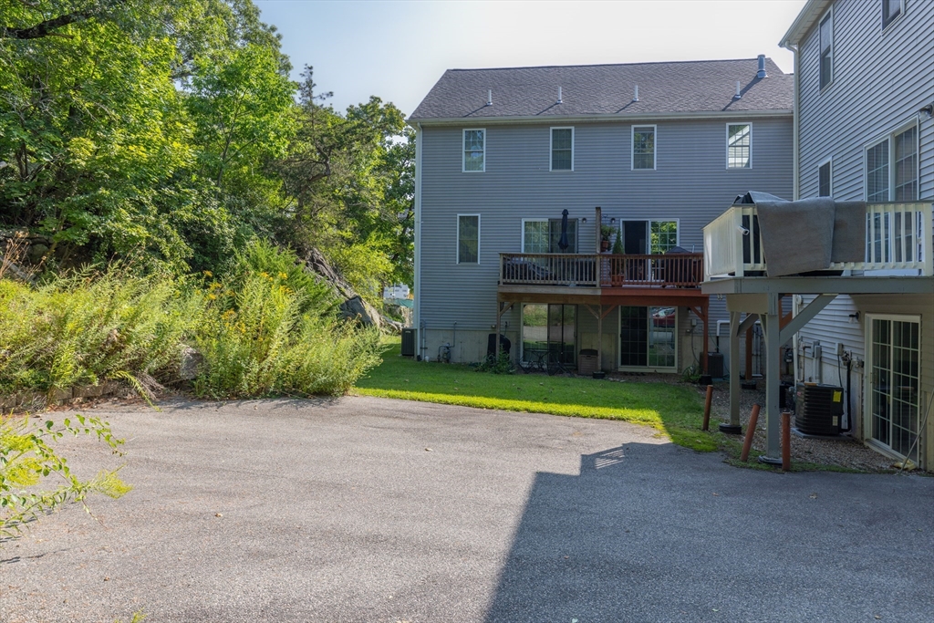 52 Packards Lane, Unit 4 Quincy, MA 02169 - Photo 38 of 40 a front view of a house with a yard and trees